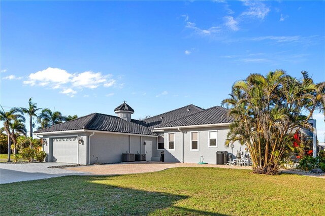 3415 Tripoli Blvd, Punta Gorda, FL 33950 - exterior space featuring central AC, a garage, and a yard