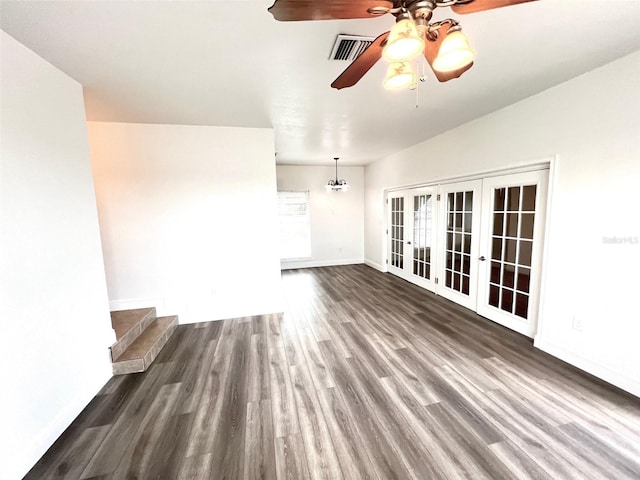 unfurnished living room with dark hardwood / wood-style floors, ceiling fan, and french doors