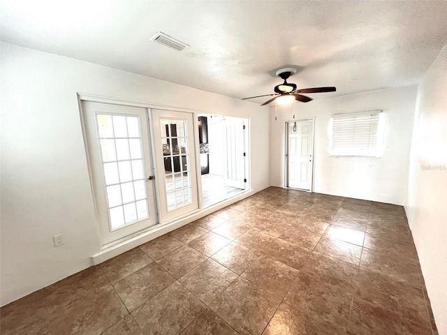 empty room with a textured ceiling and ceiling fan