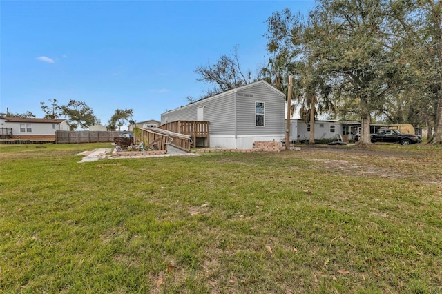 view of property exterior with a lawn and a deck