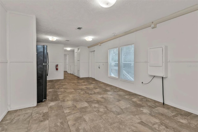 interior space with a textured ceiling