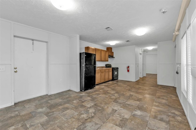 kitchen featuring a textured ceiling and black appliances