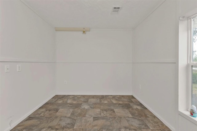 empty room with a textured ceiling