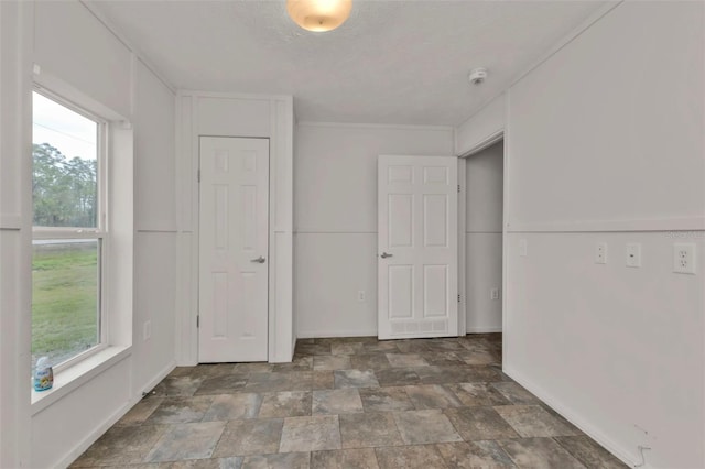 unfurnished room featuring a textured ceiling