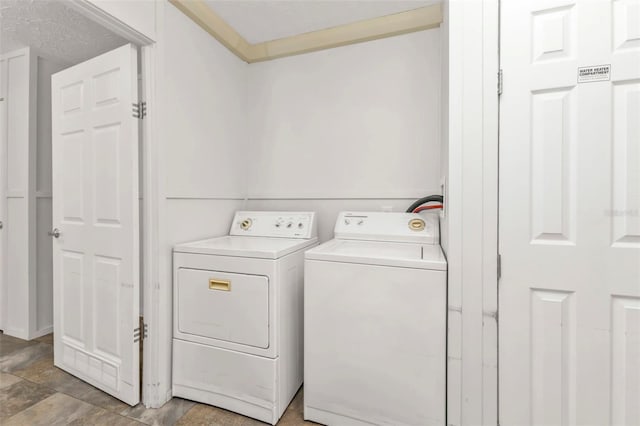 washroom featuring washing machine and dryer and a textured ceiling