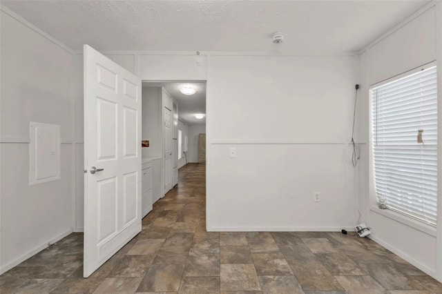 spare room with a textured ceiling