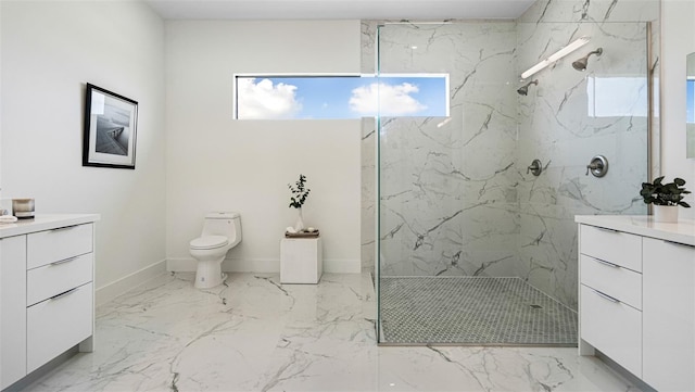 bathroom with vanity, toilet, and a tile shower