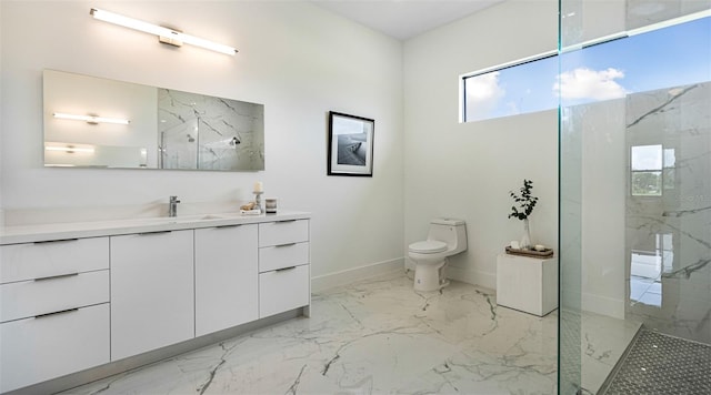 bathroom with tiled shower, vanity, and toilet