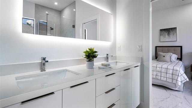 bathroom with vanity and a shower with door