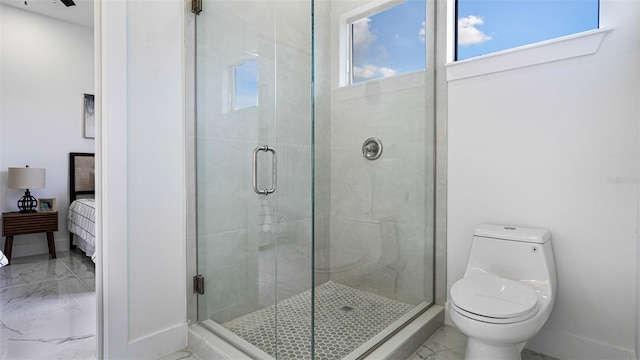 bathroom featuring toilet and an enclosed shower