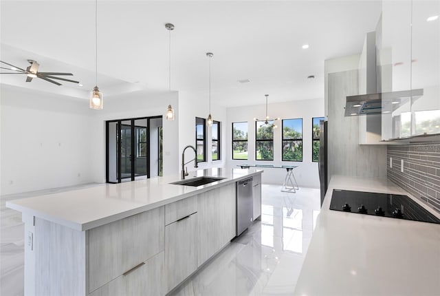 kitchen featuring pendant lighting, stainless steel appliances, sink, and a large island with sink