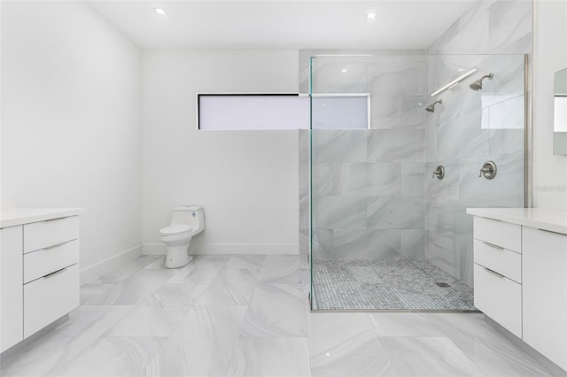 bathroom with vanity, toilet, and a tile shower