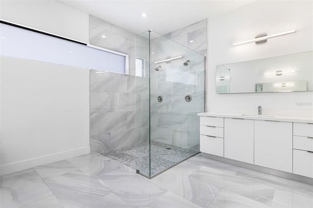 bathroom with vanity and a tile shower