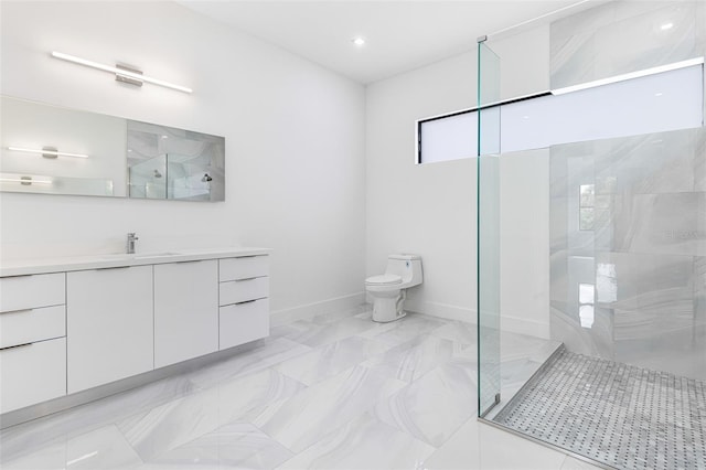 bathroom with vanity, toilet, and a tile shower