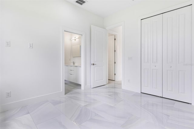 bedroom featuring sink, a closet, and ensuite bathroom