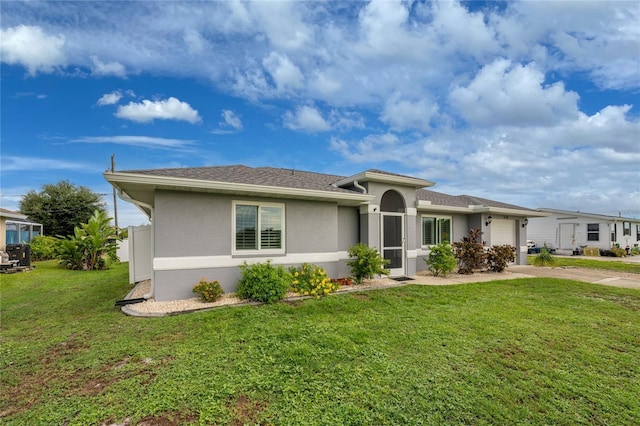 view of front of home featuring a garage and a front lawn