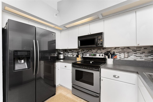 kitchen with stainless steel appliances, light tile patterned floors, white cabinets, and decorative backsplash