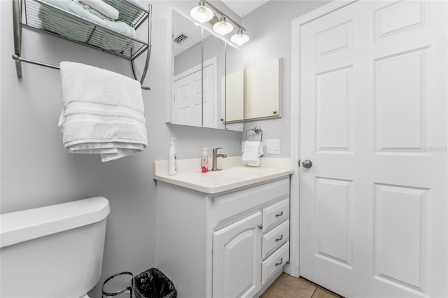 bathroom with vanity, tile patterned floors, and toilet