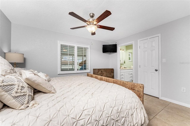 tiled bedroom featuring connected bathroom, a textured ceiling, and ceiling fan