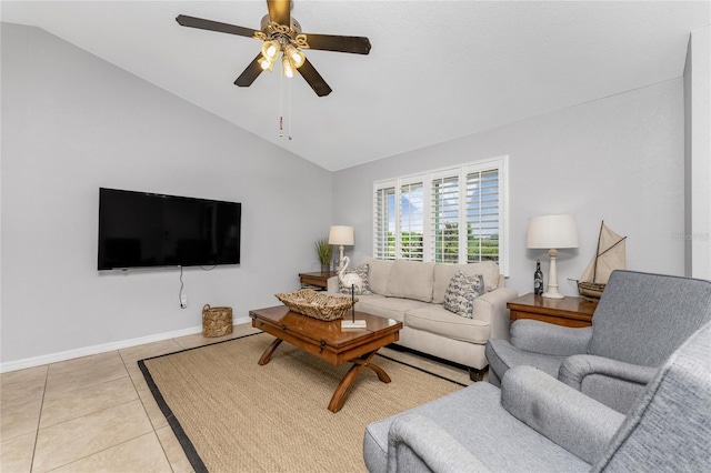 tiled living room with ceiling fan and vaulted ceiling