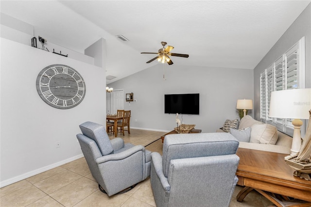 living room with vaulted ceiling, ceiling fan, and light tile patterned flooring