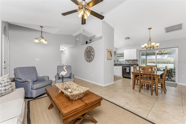 tiled living room featuring vaulted ceiling, ceiling fan with notable chandelier, and sink