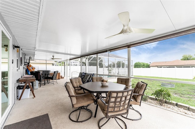 sunroom / solarium featuring ceiling fan