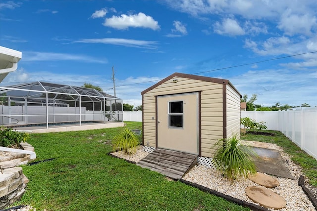 view of outbuilding with a pool and a yard