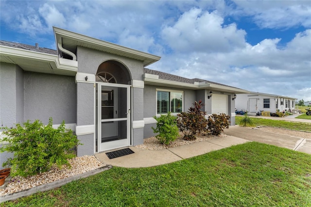 view of front of home with a garage and a front lawn