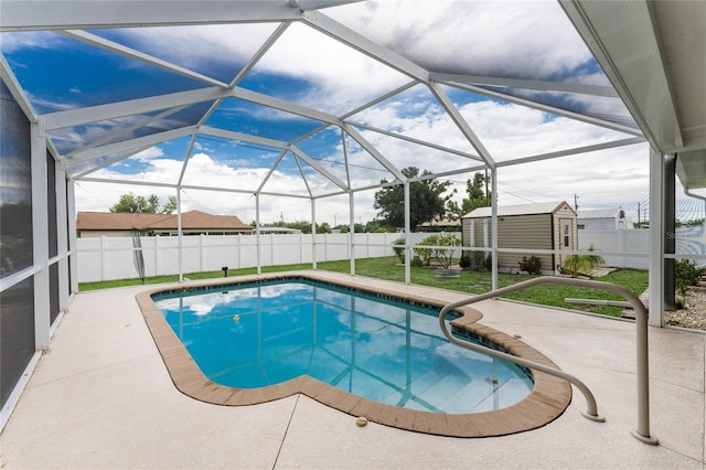 view of pool with a storage shed, a lanai, a patio area, and a lawn