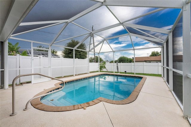 view of swimming pool with a lanai and a patio area