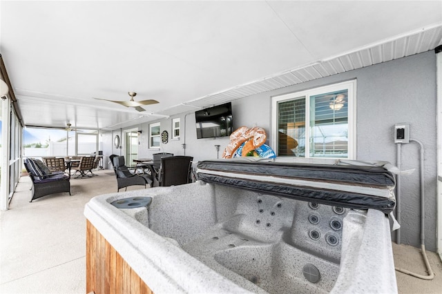 interior space featuring light carpet and ceiling fan