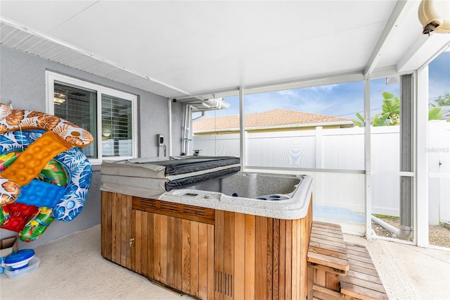 sunroom featuring a wealth of natural light and a hot tub