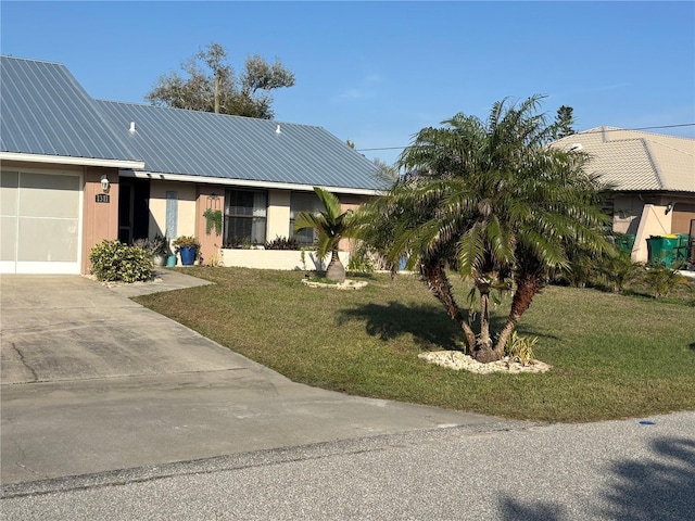 view of front of house with a garage and a front lawn