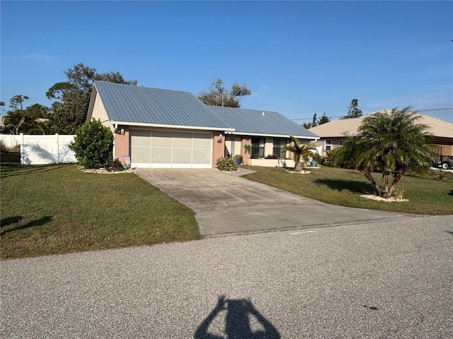 view of front of house with a garage and a front lawn