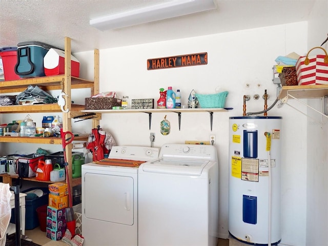 washroom featuring electric water heater, a textured ceiling, and washer and clothes dryer