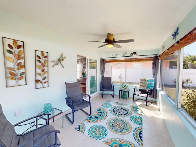 living area featuring ceiling fan and light tile patterned floors