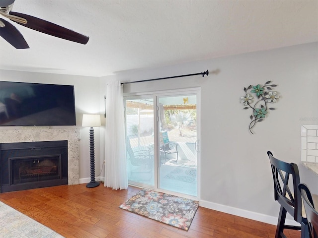 living room with hardwood / wood-style flooring and ceiling fan