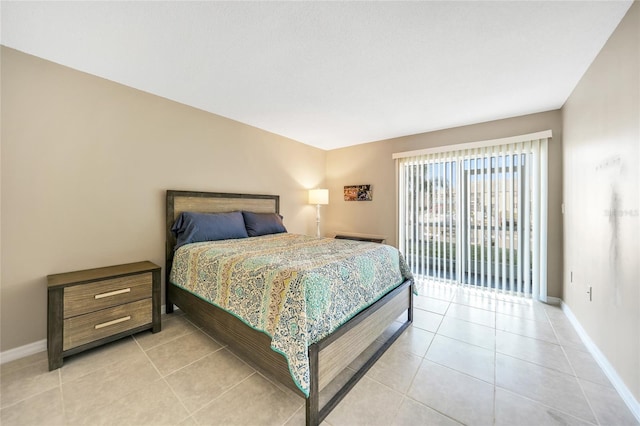 bedroom with light tile patterned floors and access to exterior