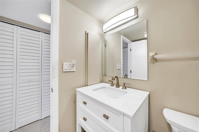 bathroom with tile patterned floors, vanity, and toilet