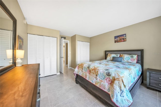 tiled bedroom with multiple closets