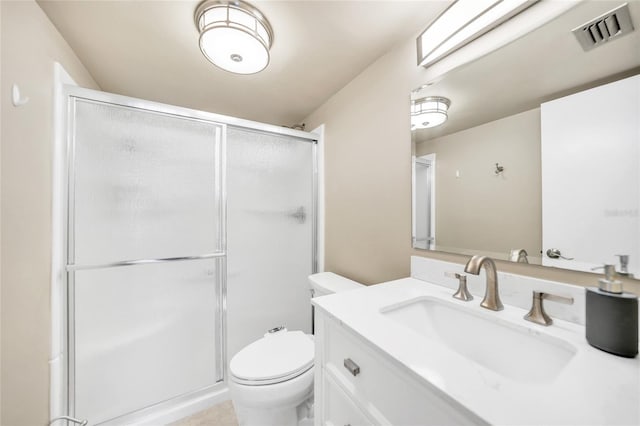 bathroom with walk in shower, vanity, and toilet