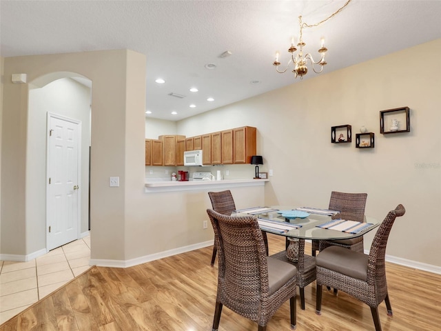 dining room featuring a notable chandelier and light hardwood / wood-style floors