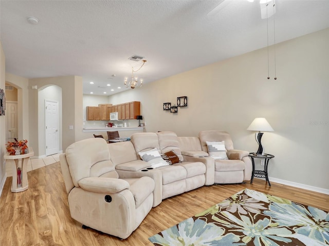 living room featuring a textured ceiling and light wood-type flooring