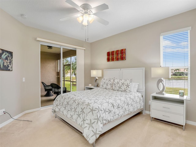 bedroom featuring light colored carpet, multiple windows, and access to outside