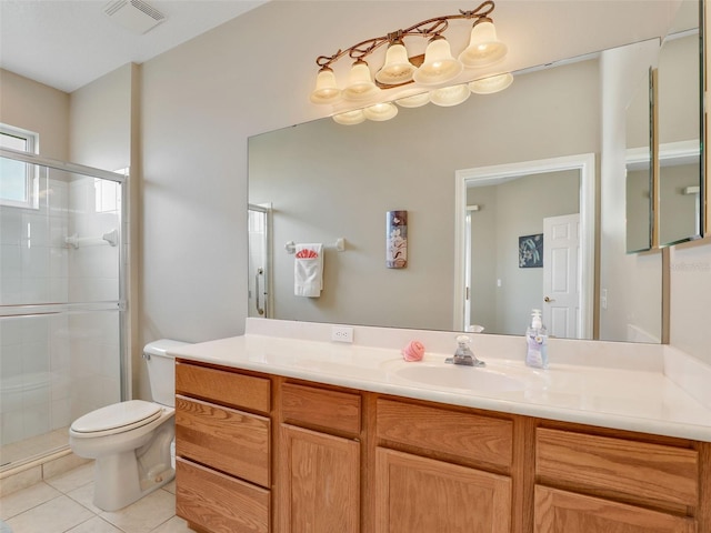 bathroom with vanity, tile patterned floors, toilet, and walk in shower