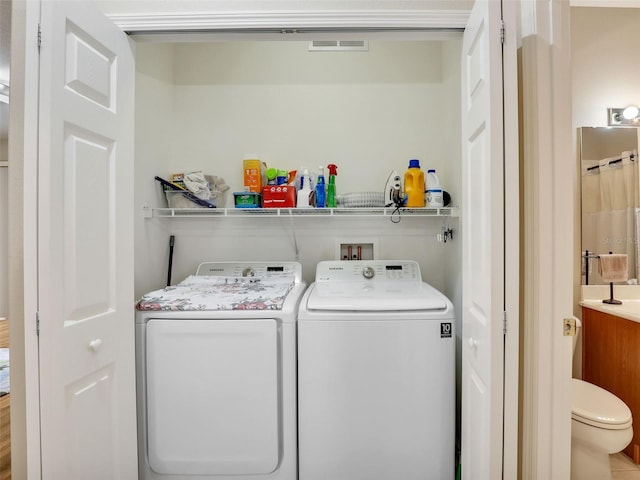 clothes washing area with washer and dryer