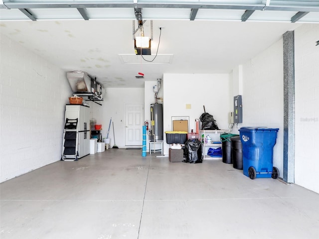 garage featuring a garage door opener, electric panel, and water heater