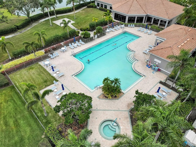 view of swimming pool featuring a hot tub and a patio