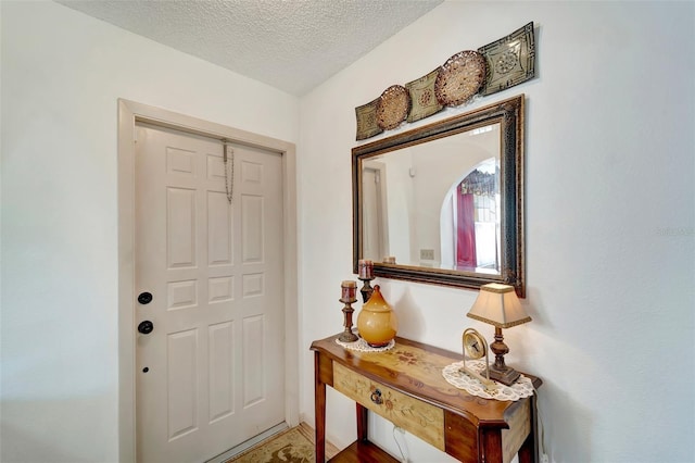 entryway featuring a textured ceiling